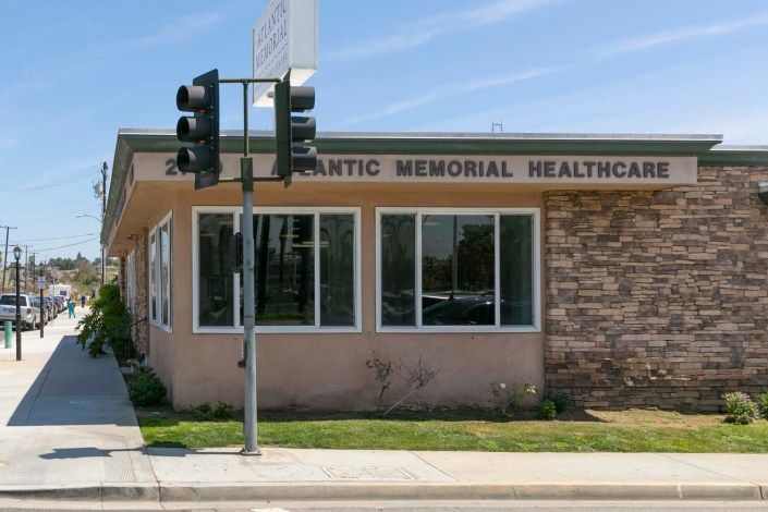 Exterior view of a healthcare clinic building on a sunny day.