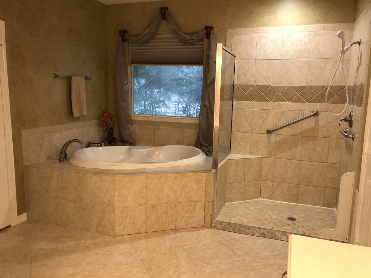 Spacious bathroom with a bathtub and walk-in shower.