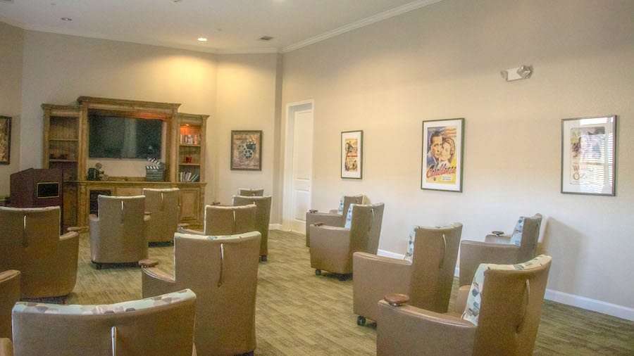 A calm waiting room with comfortable chairs and artwork on the walls.