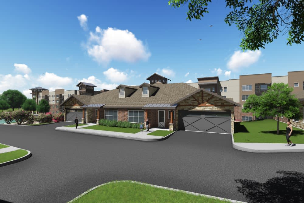 A suburban residential house with a driveway under a clear blue sky.
