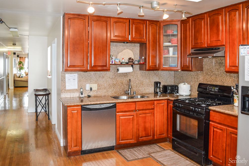 A modern kitchen with wooden cabinets and stainless steel appliances.