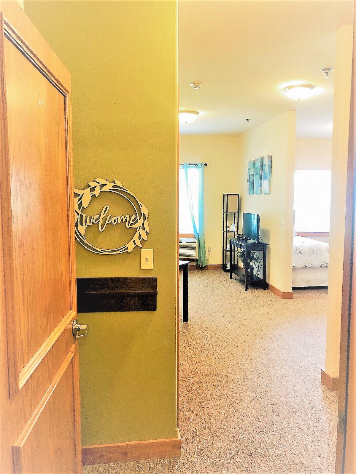 A welcoming view into a cozy living area through an open door.