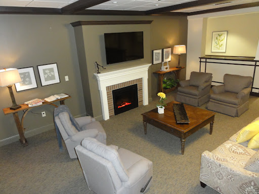 A cozy and modern living room featuring comfortable seating, a fireplace, and a television.