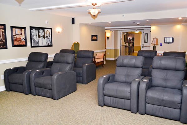 A modern lounge area featuring multiple recliner chairs arranged in rows.