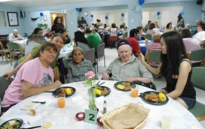 A group of people enjoying a meal together at a community event.