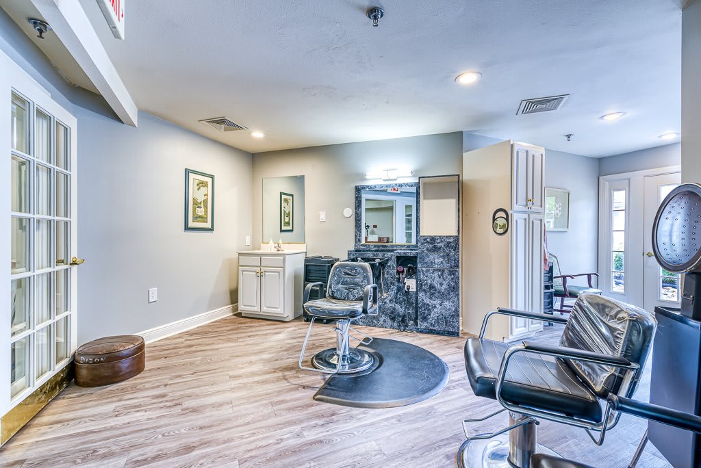A modern and well-lit salon interior with styling chairs and mirrors.