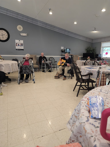 Residents enjoying a musical performance in a community center.