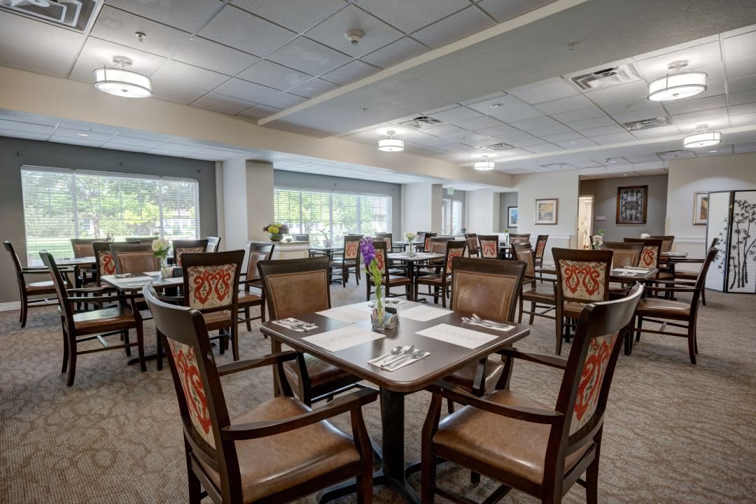 Spacious and well-lit dining area with neatly arranged tables and chairs.