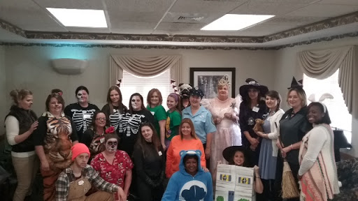 A lively gathering of individuals dressed in creative costumes for a Halloween celebration.