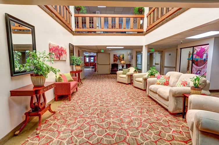 A cozy lobby area with comfortable seating and decorative plants.