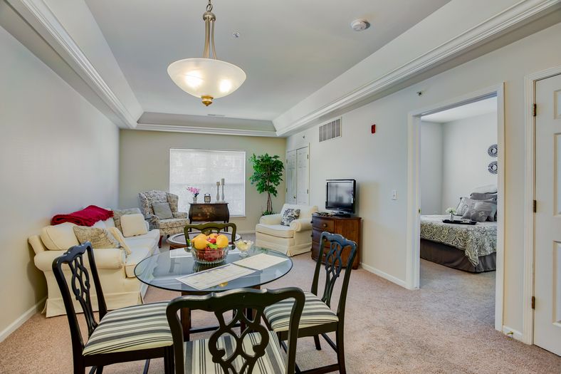 A cozy living and dining area with modern furnishings and neutral tones.