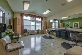 Interior view of a spacious hair salon with chairs and mirrors.