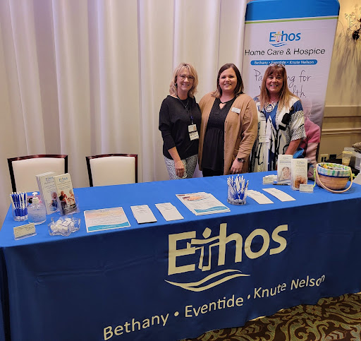 Representatives from Ethos at an event showcasing their services.