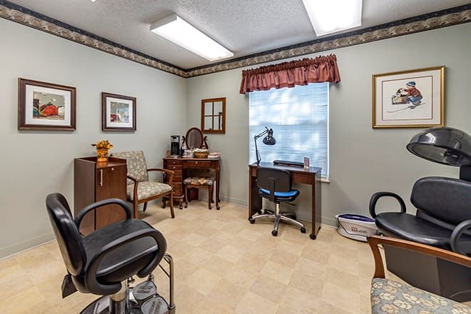 A well-organized office space with multiple chairs, a desk, and a computer by the window.