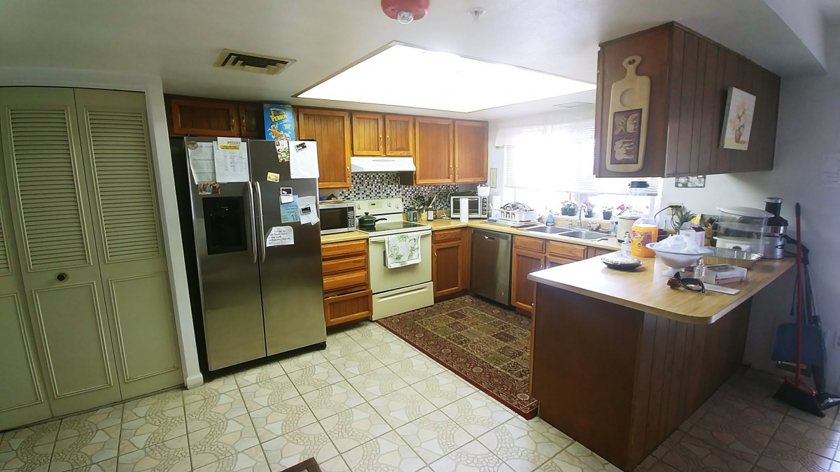 A cozy kitchen with wooden cabinets and modern appliances.