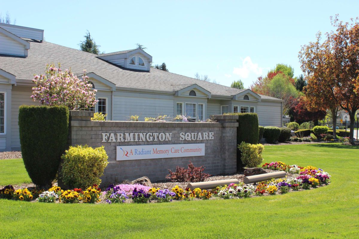 A landscaped entrance sign to a residential estate with flowers and greenery.