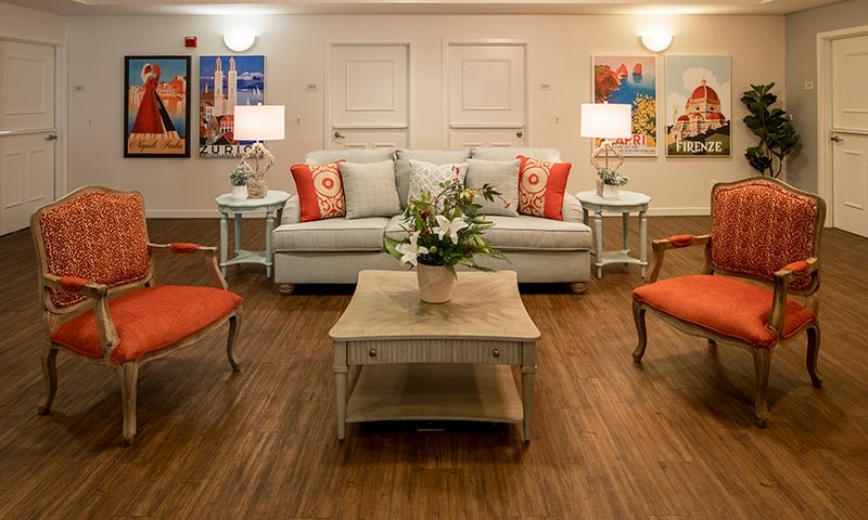 A cozy living room with a stylish sofa, vibrant pillows, and tasteful artwork.