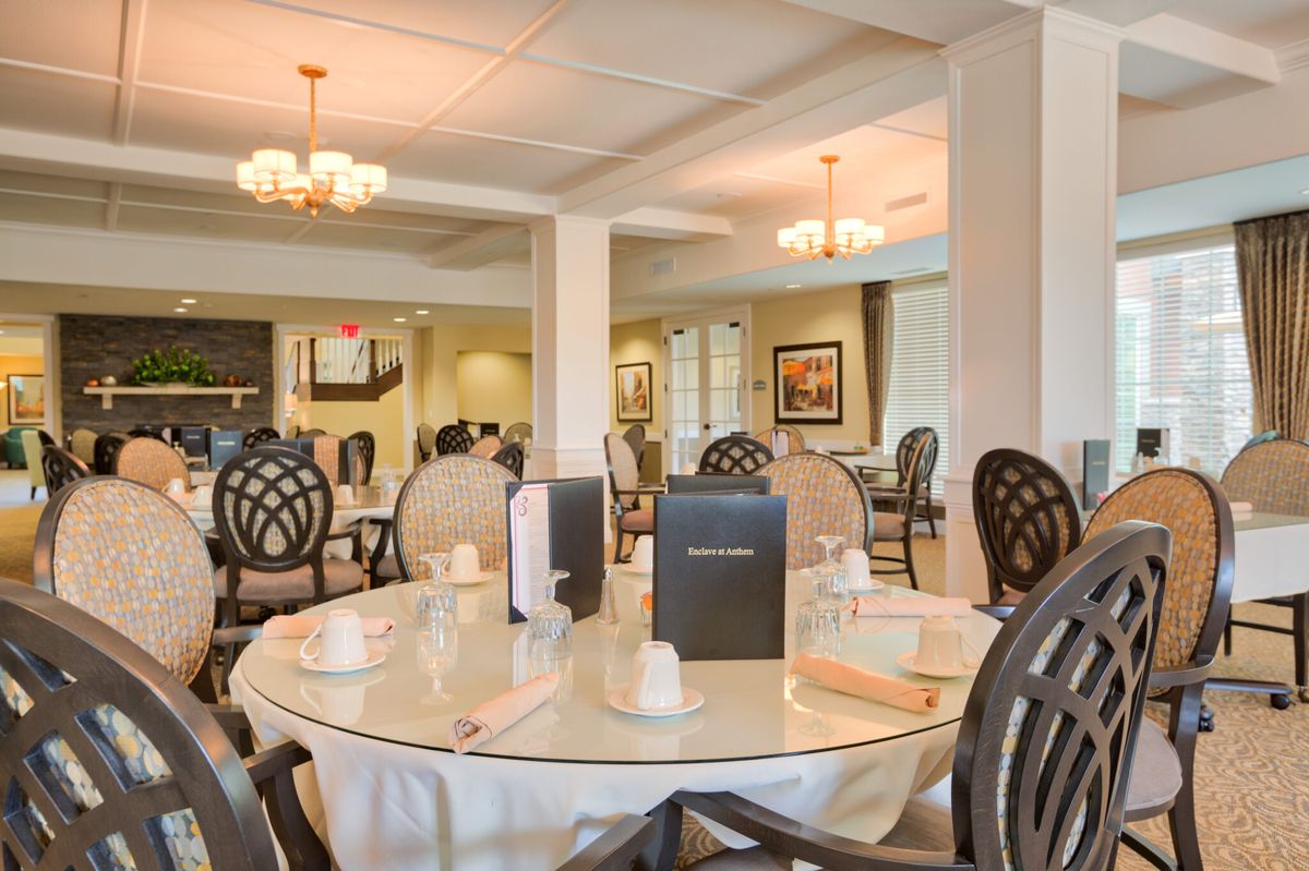 A well-lit restaurant dining area with elegantly set tables and stylish chairs.