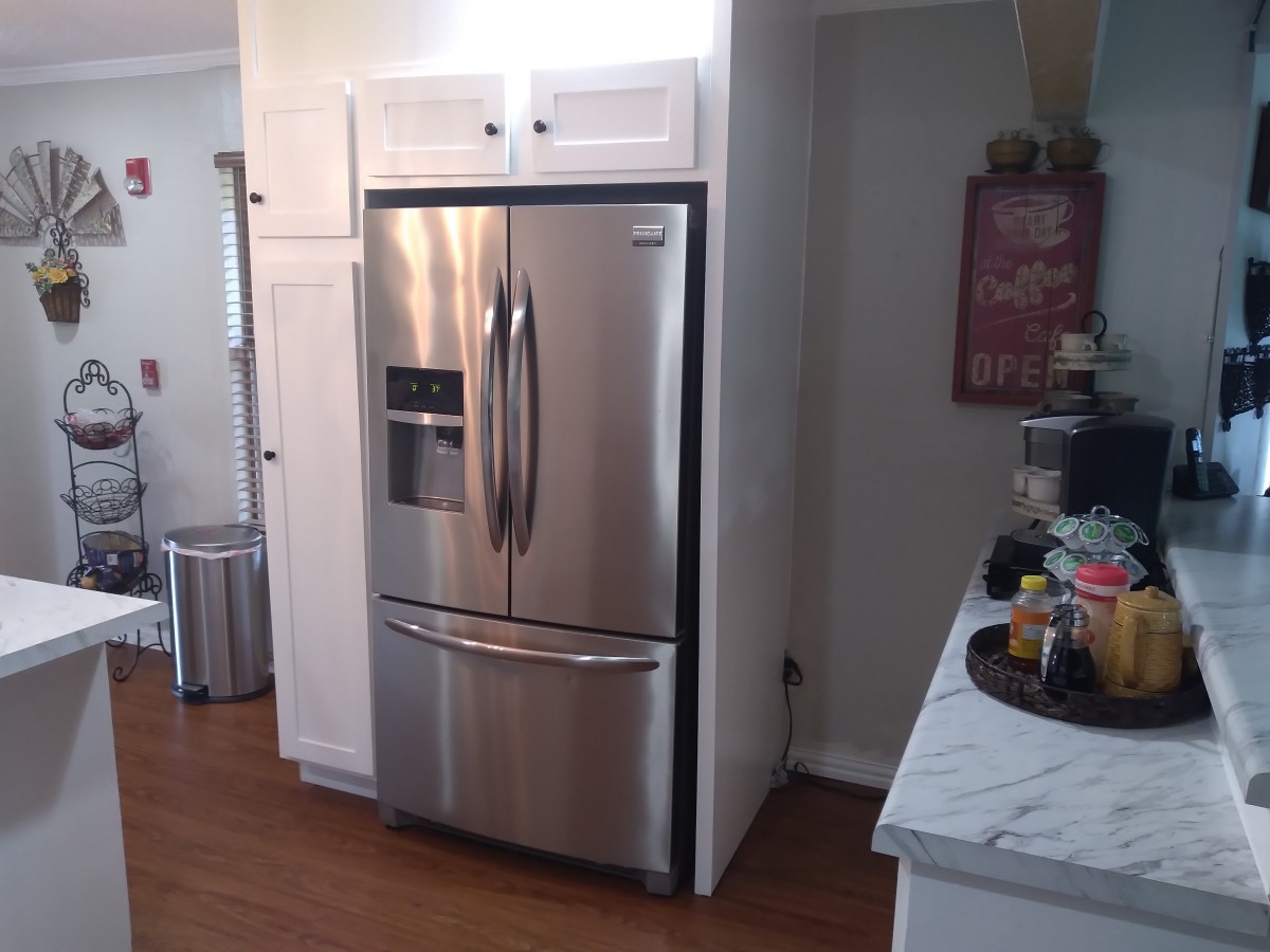 A modern kitchen featuring a stainless steel refrigerator.