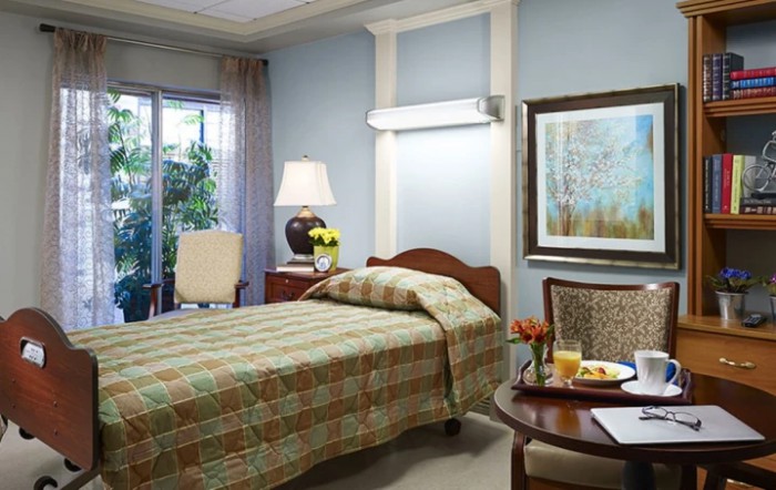A cozy bedroom with a single bed, lamp, and a painting on the wall.