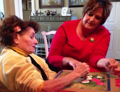 Two people engaging in a crafting activity at home.