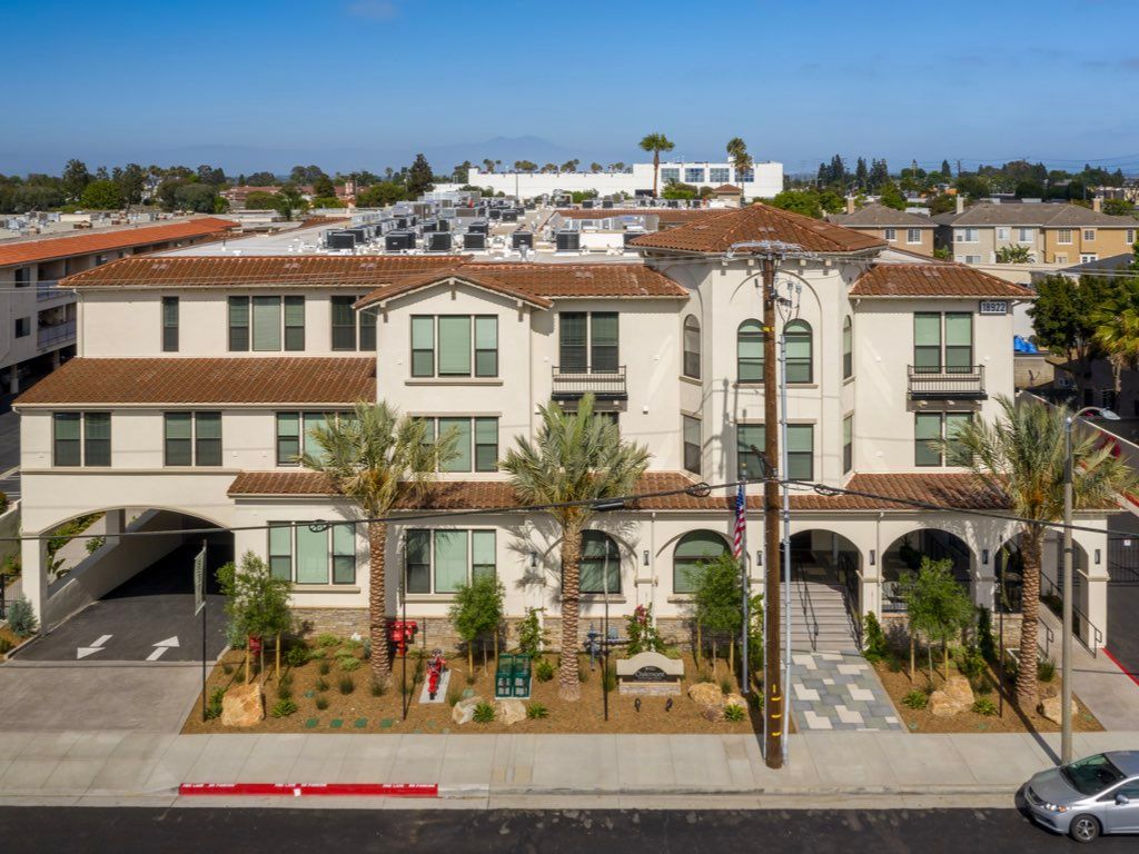 A modern residential apartment complex with landscaped surroundings.