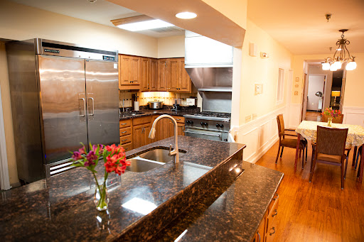 A modern kitchen featuring elegant wooden cabinets, sleek granite countertops, and modern appliances.