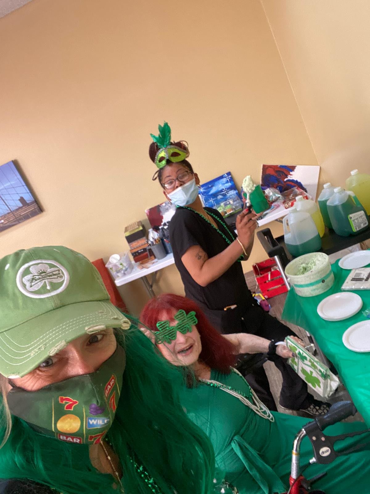 A group of people celebrating St. Patrick's Day with festive decorations and outfits.