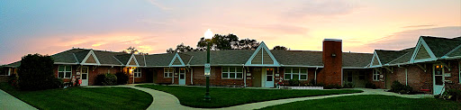 A charming residential building illuminated by a streetlight during sunset.