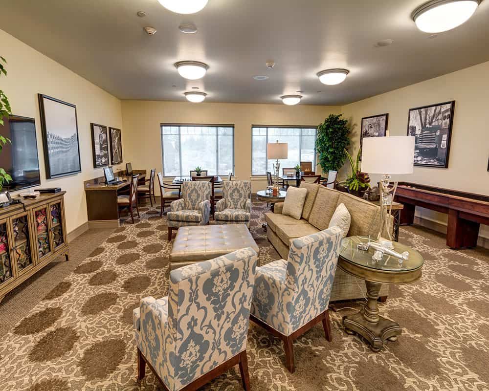 A cozy and well-furnished living room with comfortable seating and warm lighting.