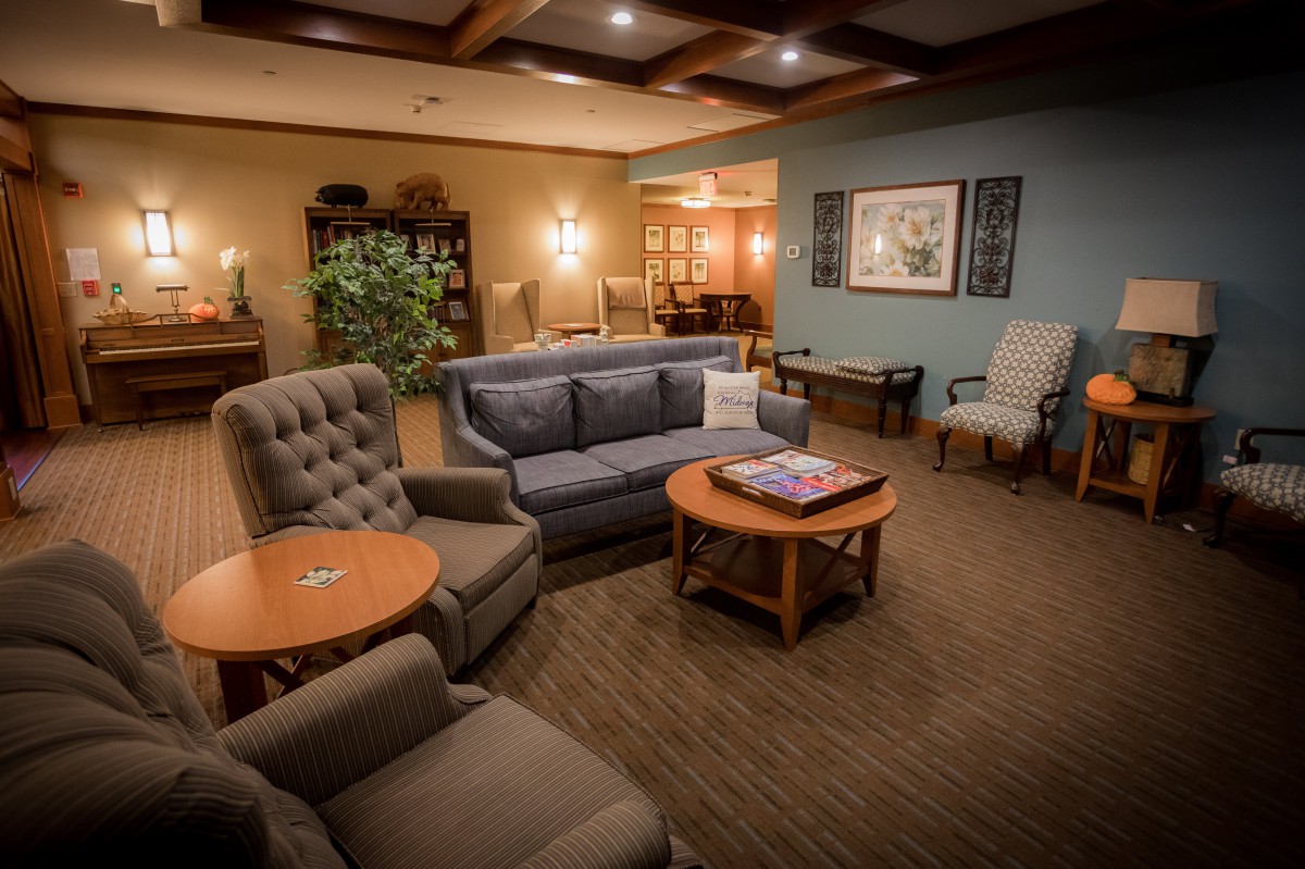 A cozy living room with comfortable seating and warm lighting.