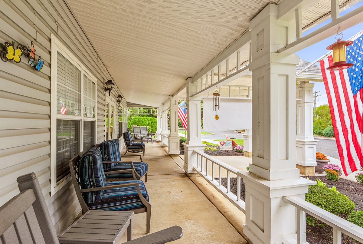 A welcoming porch with comfortable seating and classic design elements.
