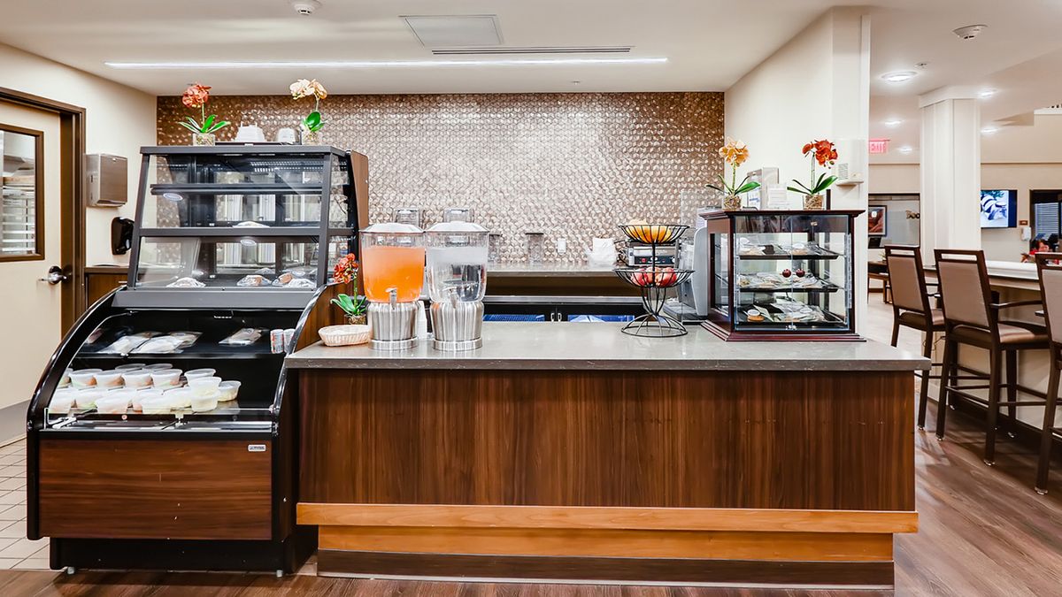A cozy cafe counter with a variety of beverages and pastries on display.