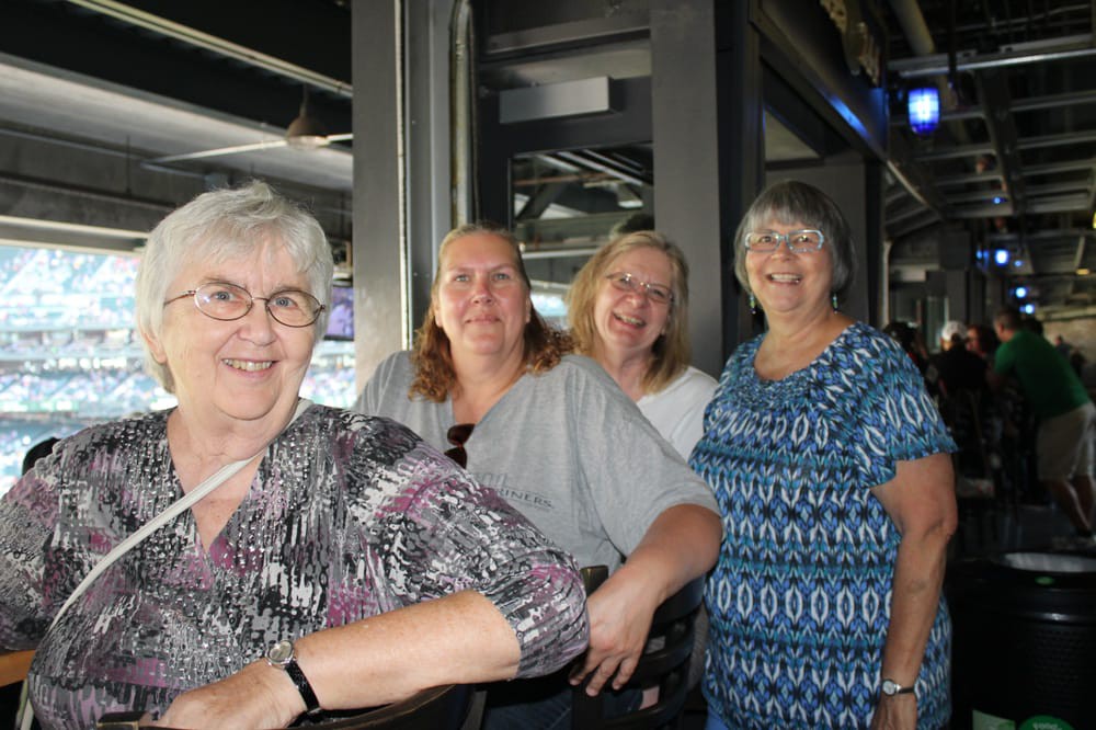 A group of women smiling together indoors.