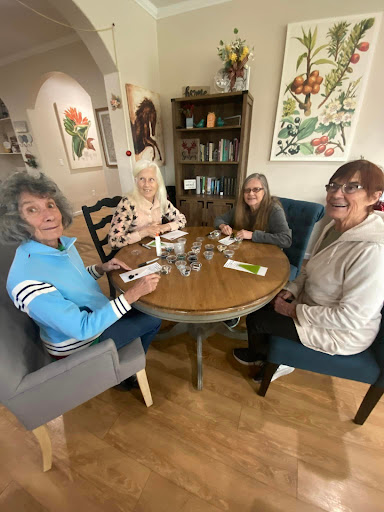 A cozy gathering of friends enjoying their time together around a table.