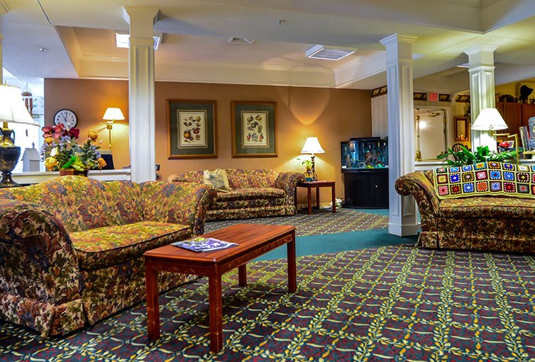 A cozy hotel lobby with patterned carpets and comfortable seating.