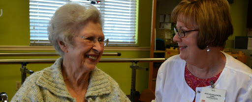 A joyful moment shared between a senior woman and her caregiver.