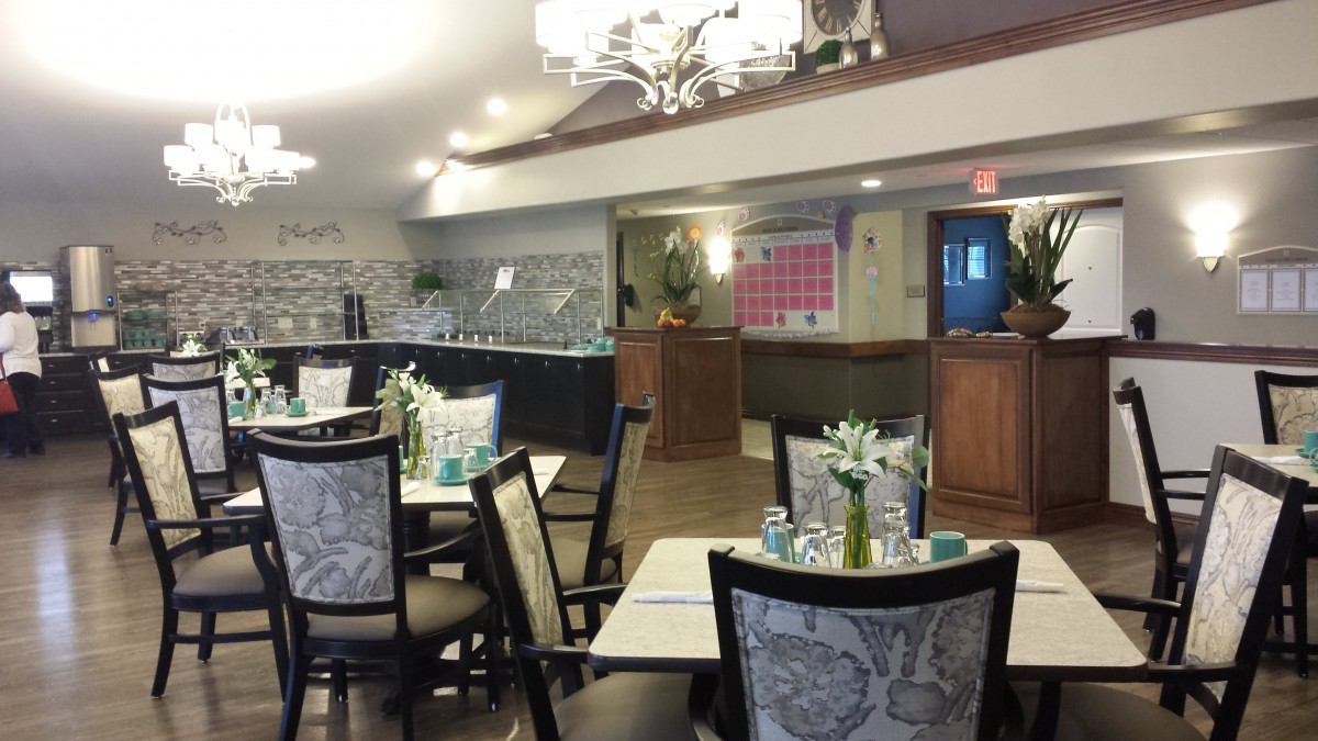 A cozy restaurant dining area with elegantly set tables and stylish chairs.