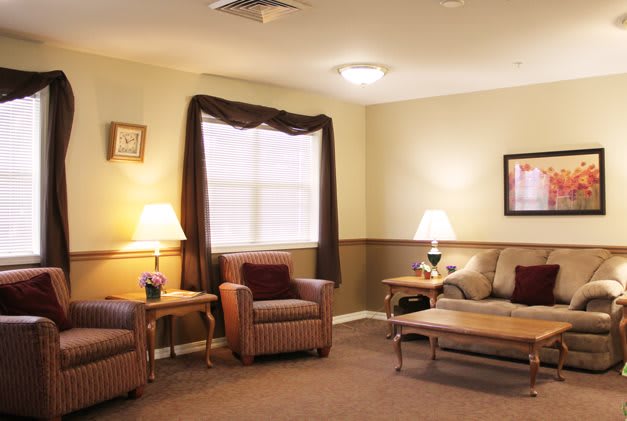 A cozy living room with comfortable seating and warm lighting.