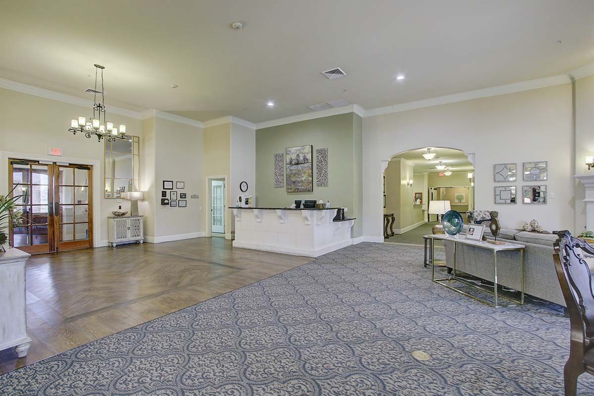 A spacious and elegantly designed lobby with a reception desk and comfortable seating.