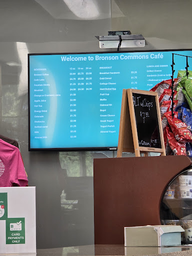 Digital menu board displaying food options in a welcoming cafe environment.