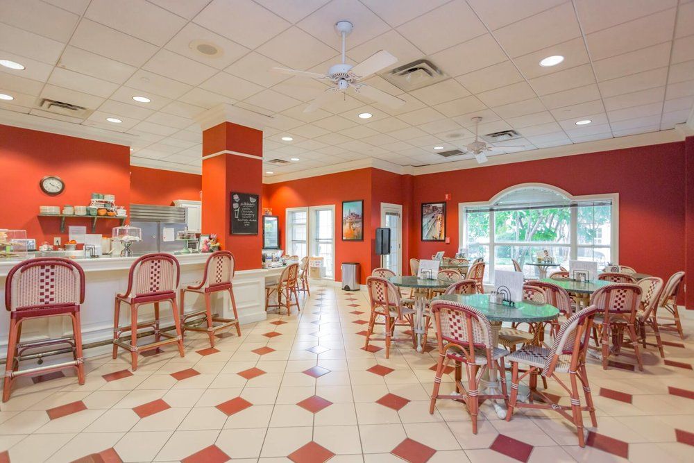 Bright and colorful cafe interior with dining tables and chairs.