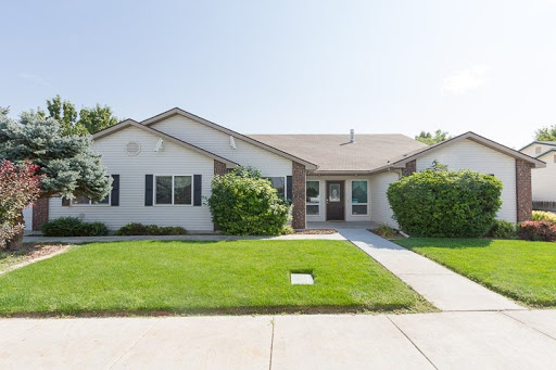 A charming single-story house with a well-maintained front yard.
