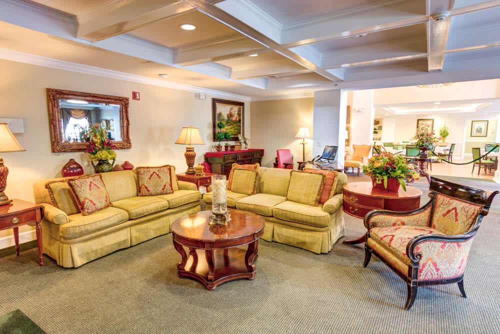 A cozy living room featuring a stylish sofa set, wooden coffee table, and elegant decor elements.