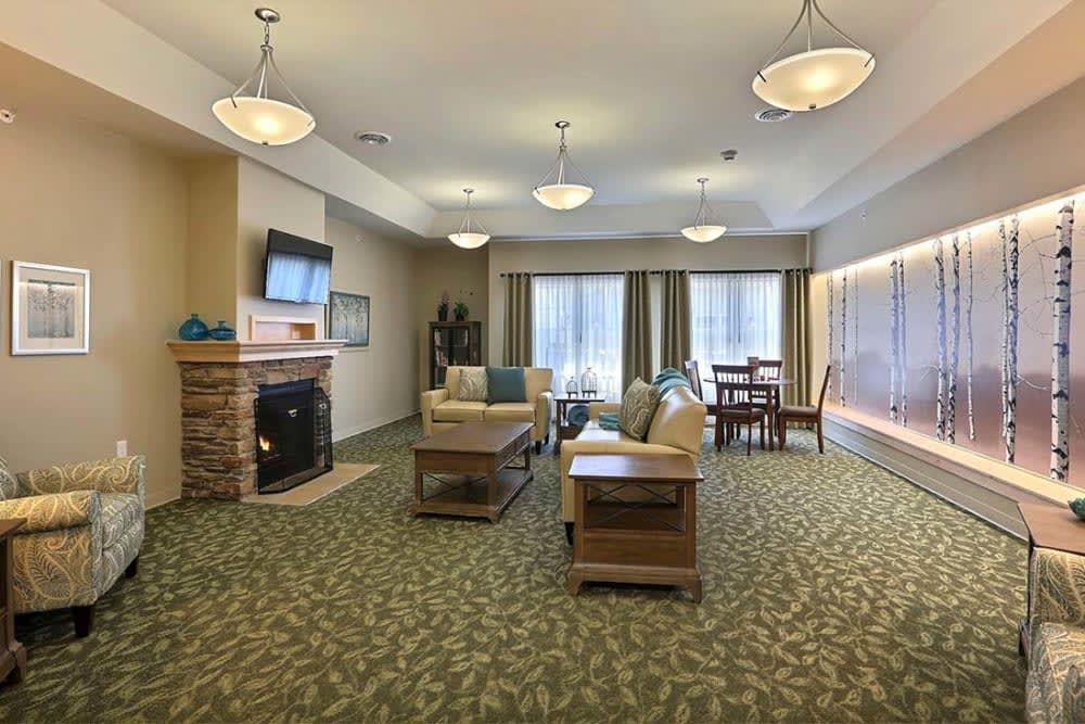 A cozy living room with a fireplace, TV, and comfortable seating.
