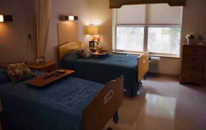 A shared hospital room with two beds equipped for patient care.