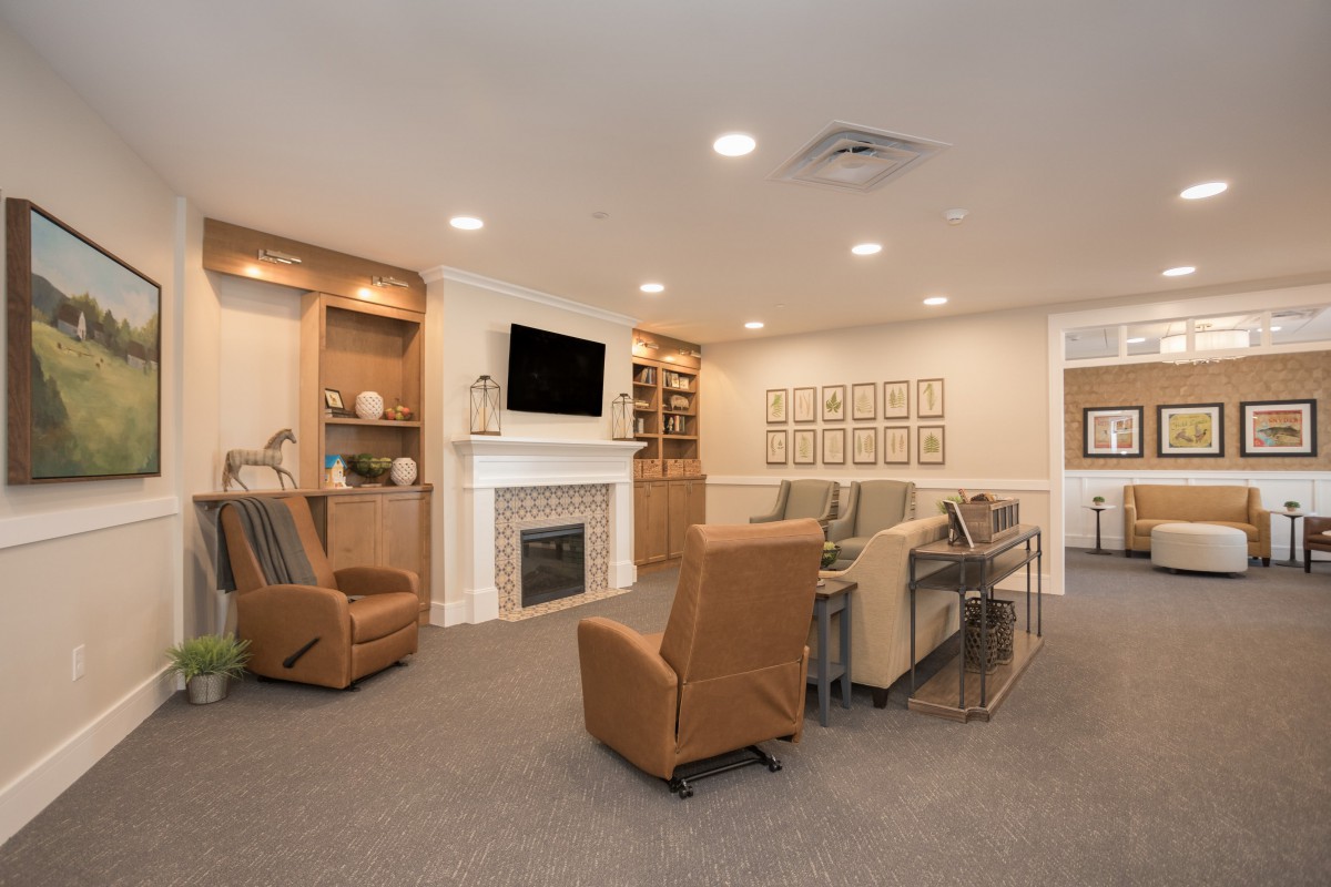 Modern living room with a fireplace and comfortable seating.