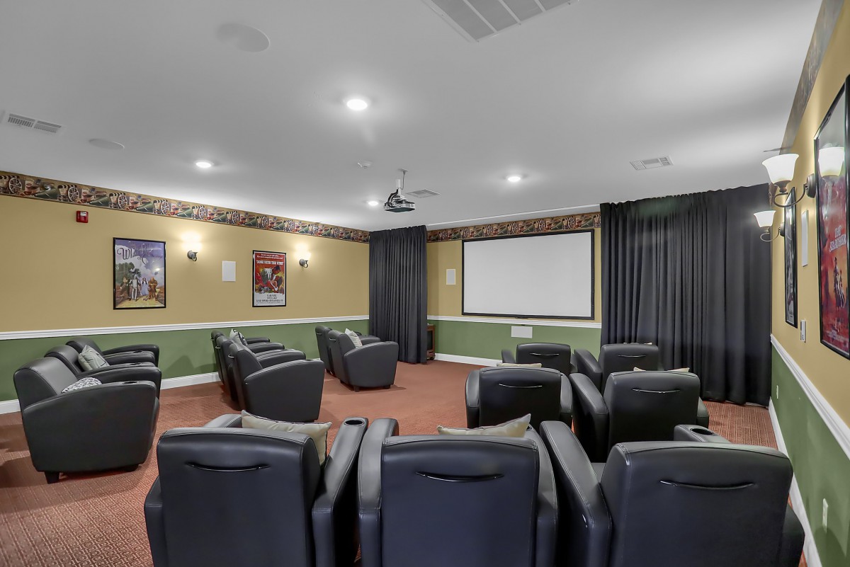A cozy home theater with comfortable seating and a large screen.