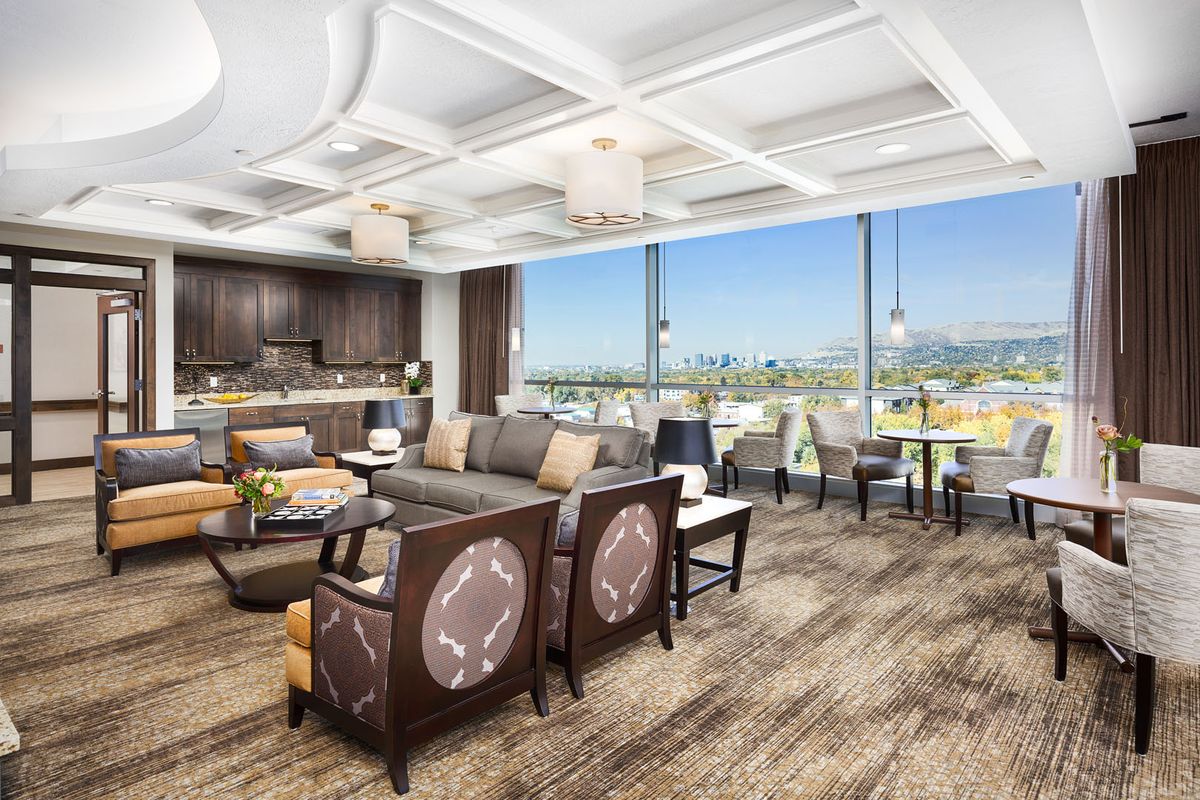 A spacious, modern living area with an open floor plan and a panoramic city view.