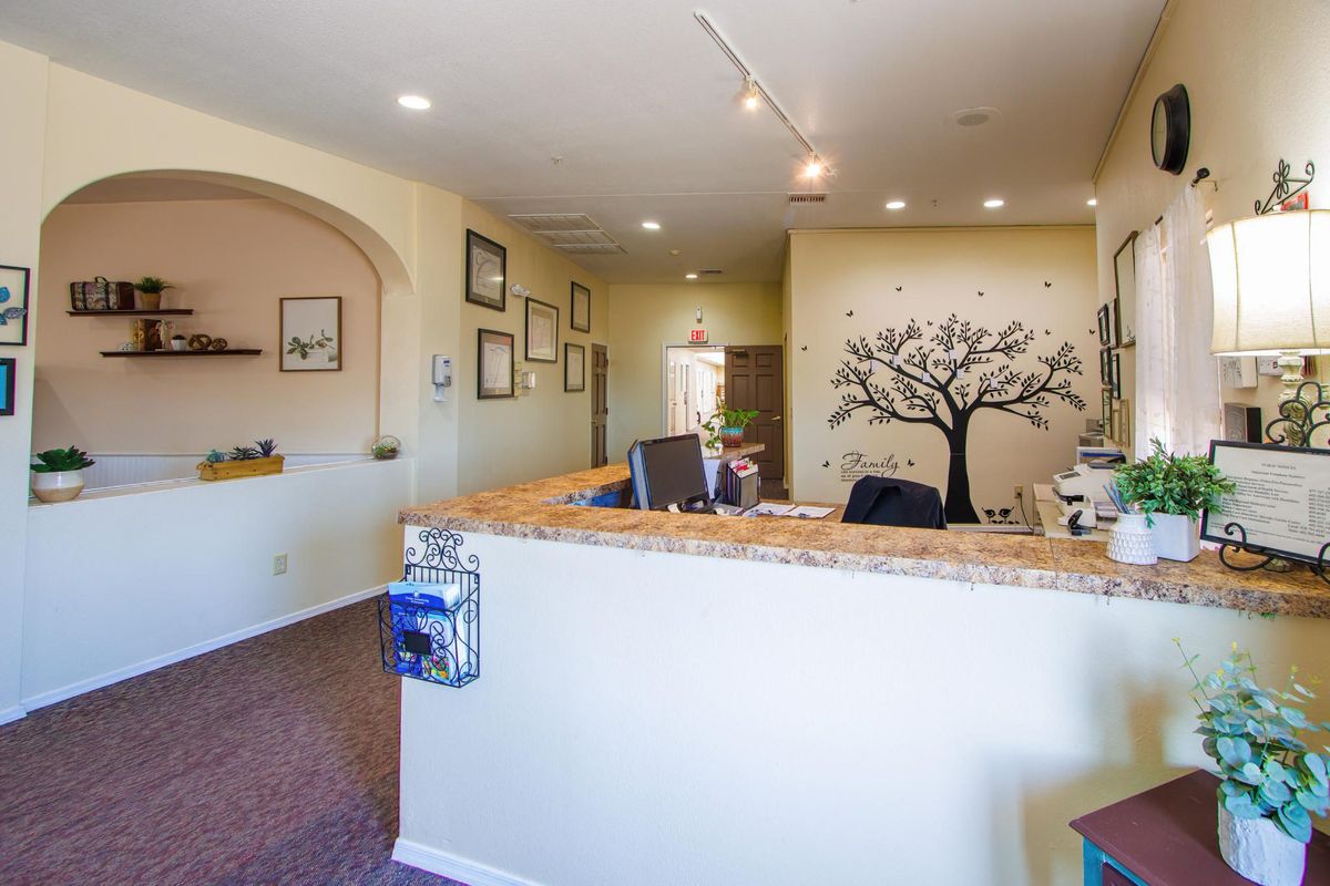 A modern office reception area with a decorative wall mural and desk.